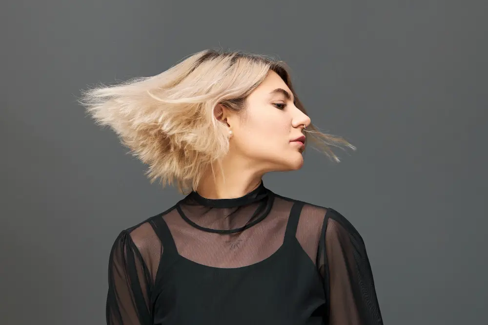 people-lifestyle-fun-festivity-party-concept-isolated-shot-good-looking-charming-young-female-with-bob-blonde-hairstyle-enjoying-nice-music-dancing-with-eyes-closed-hair-flowing-wind